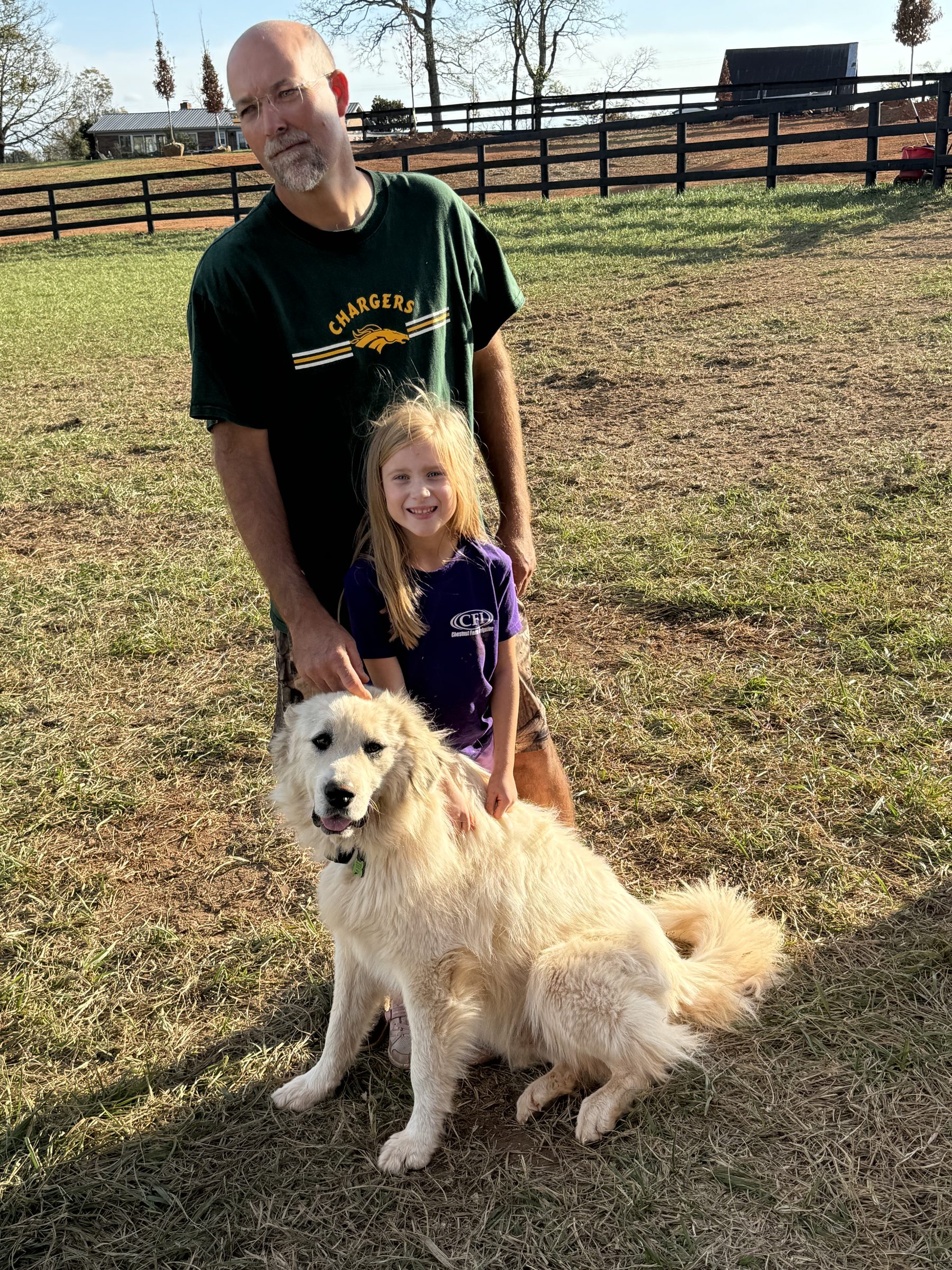 Family with their Great Pyrenees on the farm