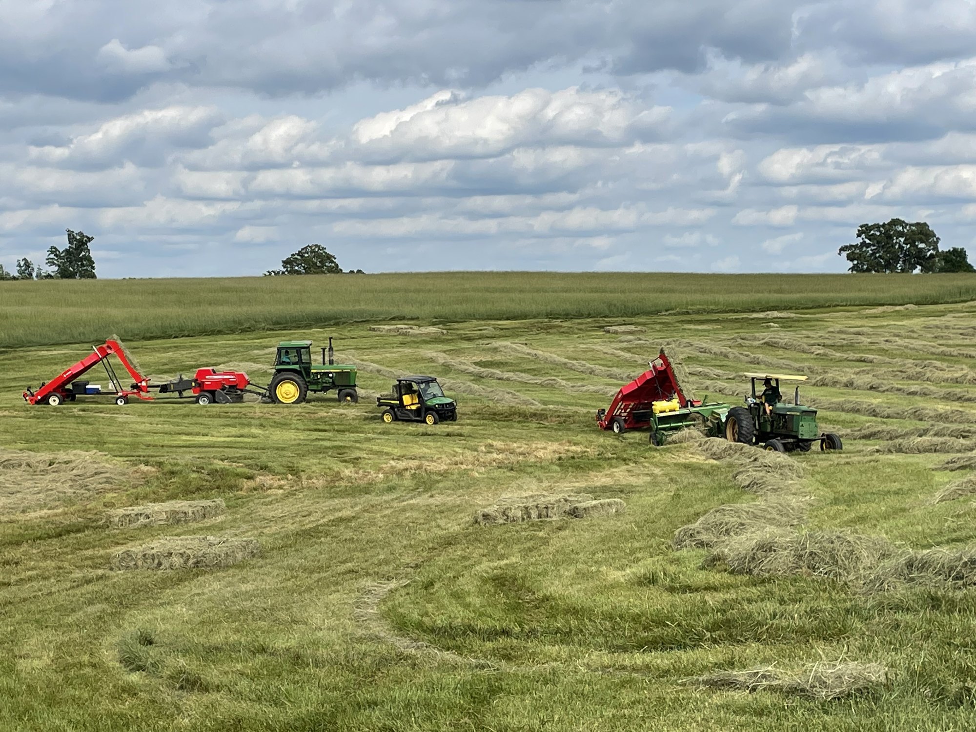 The full Warbridge hay crew working the field with two baler-and-accumulator setups