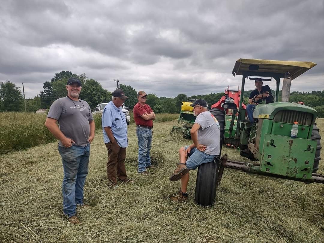 The Warbridge hay crew in the field on a stormy summer day